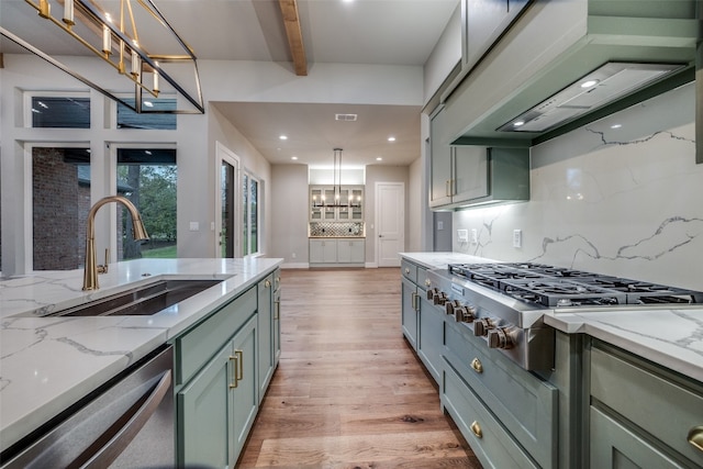 kitchen with pendant lighting, beamed ceiling, backsplash, sink, and light hardwood / wood-style floors