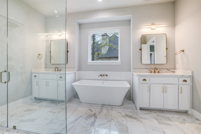 bathroom featuring vanity with extensive cabinet space, dual sinks, a bath to relax in, and tile floors