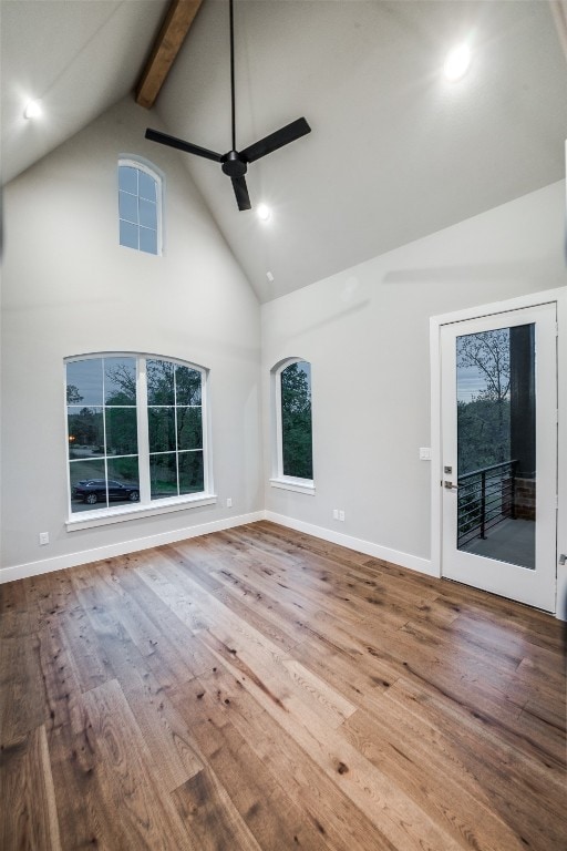 spare room featuring high vaulted ceiling, ceiling fan, hardwood / wood-style flooring, and beam ceiling