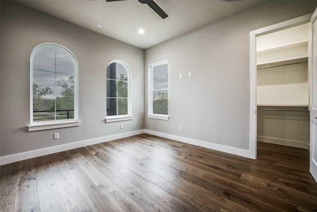 empty room featuring dark hardwood / wood-style floors and ceiling fan