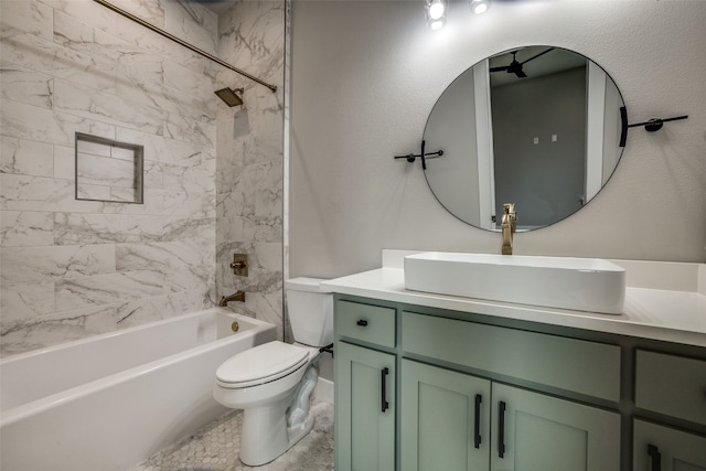 full bathroom featuring tiled shower / bath, toilet, and vanity