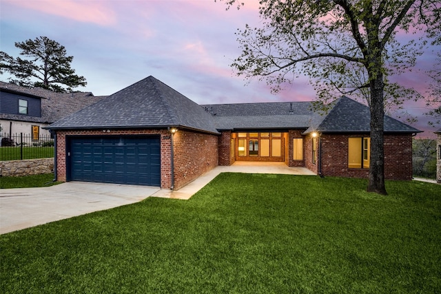 view of front facade with a garage and a lawn