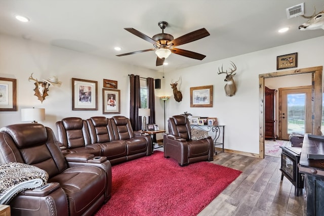 living room with dark hardwood / wood-style floors and ceiling fan