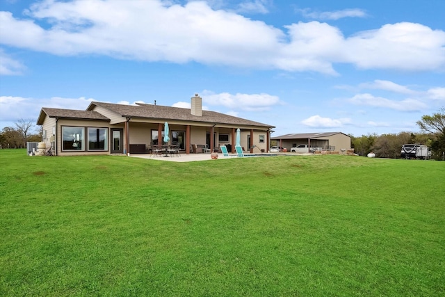 812 Mckenzie Rd, Tioga, TX 76271 - back of property with a chimney, a patio area, and a lawn