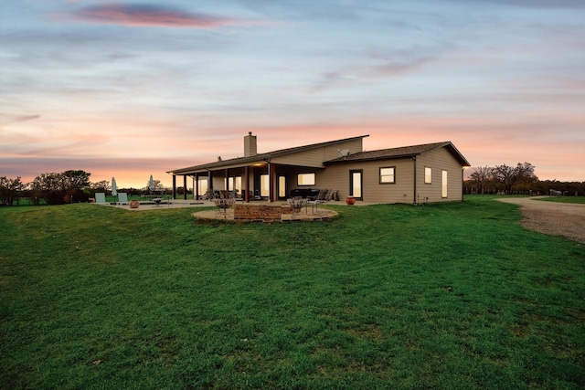 812 Mckenzie Rd, Tioga, TX 76271 - back of property with a patio, a chimney, and a lawn