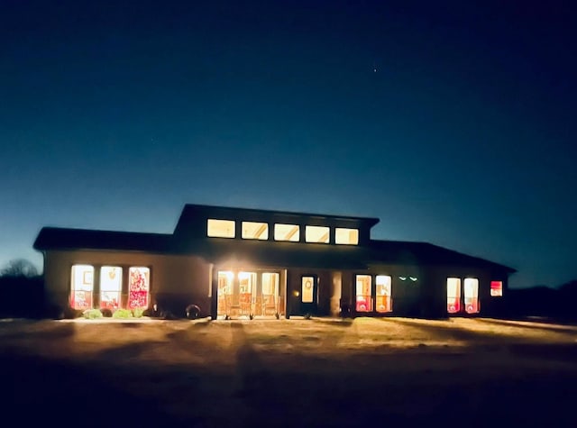 812 Mckenzie Rd, Tioga, TX 76271 - back of house at night with dirt driveway