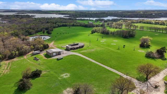 birds eye view of property featuring a water view and a rural view