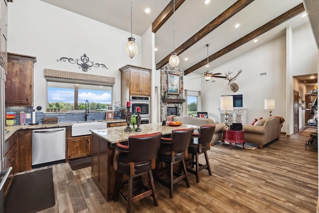 812 Mckenzie Rd, Tioga, TX 76271 - kitchen featuring high vaulted ceiling, a fireplace, ceiling fan, stainless steel appliances, and a sink