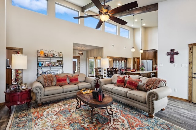 living room featuring a high ceiling, ceiling fan, and dark hardwood / wood-style floors