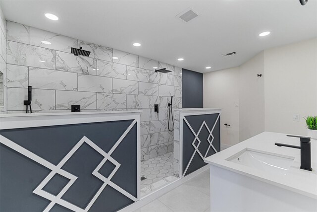 bathroom featuring tile patterned floors, vanity, and tiled shower