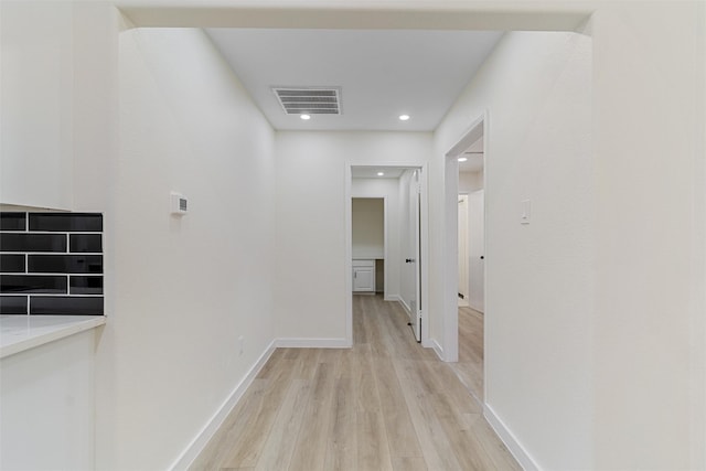 corridor with light hardwood / wood-style floors