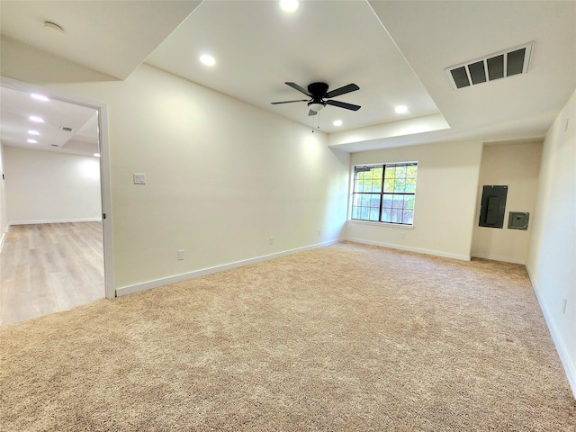 carpeted spare room featuring electric panel and ceiling fan