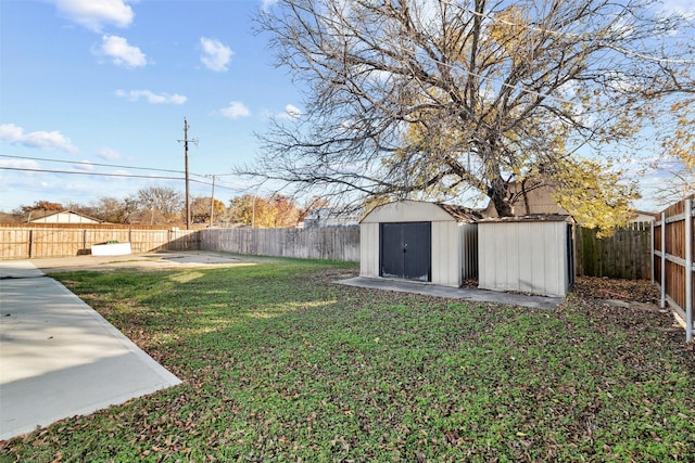 view of yard featuring a storage shed and a patio