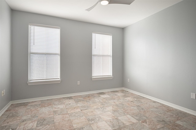 unfurnished room with ceiling fan and a healthy amount of sunlight