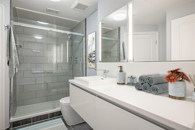 bathroom with toilet, walk in shower, tile patterned floors, and vanity