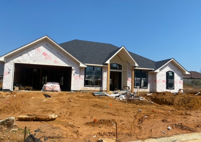 unfinished property featuring a garage