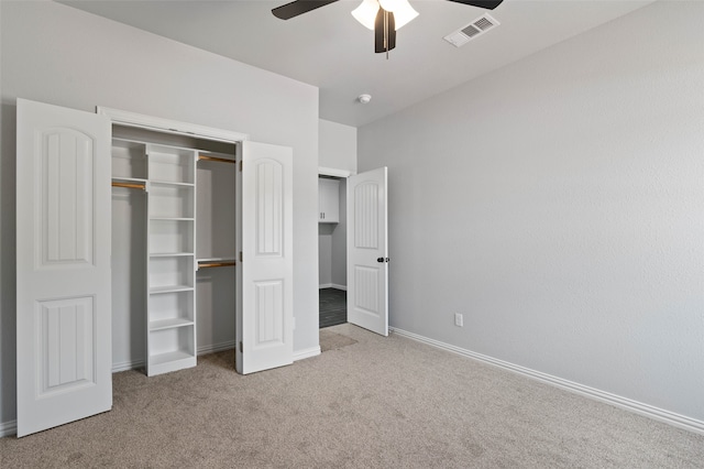 unfurnished bedroom with ceiling fan, a closet, and light colored carpet