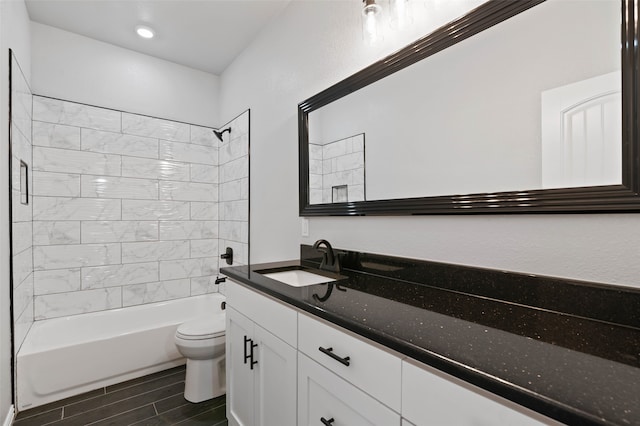 full bathroom featuring vanity, toilet, and tiled shower / bath