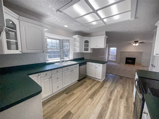 kitchen with white cabinetry, ceiling fan, light wood-type flooring, and sink