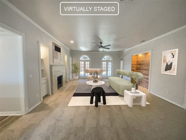 carpeted living room with ornamental molding and ceiling fan