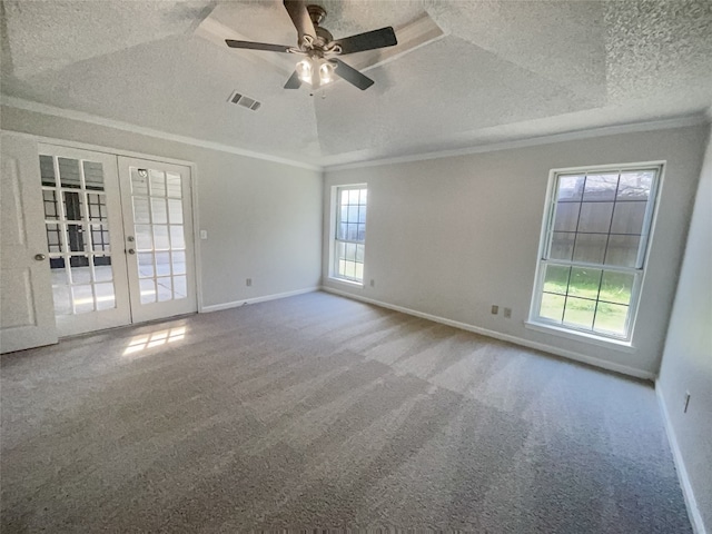 unfurnished room with french doors, ceiling fan, a raised ceiling, light carpet, and a textured ceiling