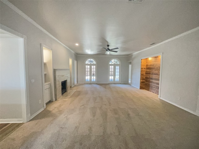 unfurnished living room featuring light colored carpet, ornamental molding, and ceiling fan