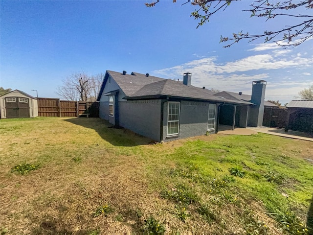 exterior space with a yard, a shed, and a patio