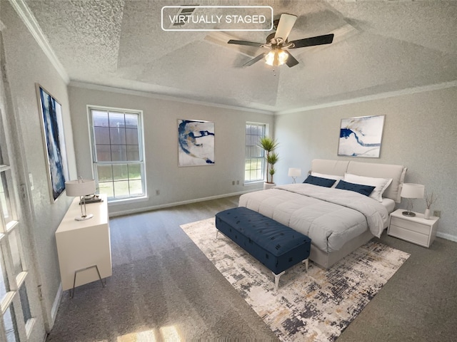 carpeted bedroom featuring a raised ceiling, ornamental molding, ceiling fan, and a textured ceiling