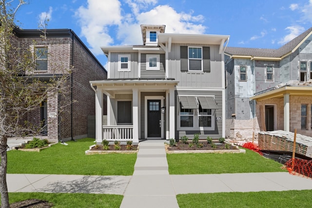 view of front of property with a front lawn and covered porch