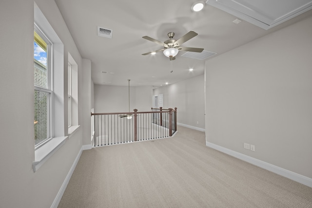 carpeted spare room with ceiling fan