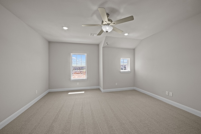 empty room with carpet, vaulted ceiling, and ceiling fan