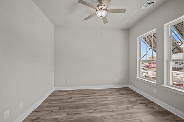 unfurnished room with ceiling fan, plenty of natural light, and light hardwood / wood-style flooring