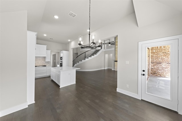 interior space with dark hardwood / wood-style flooring and a notable chandelier