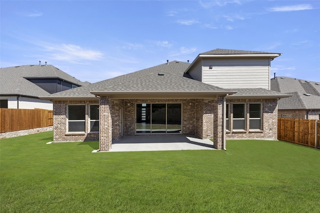 rear view of property featuring a yard and a patio