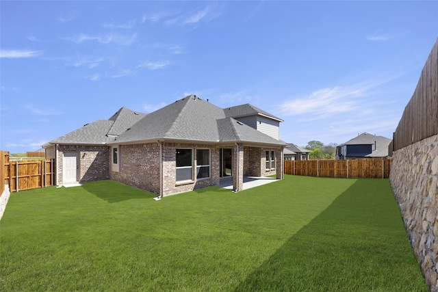 back of property featuring a yard and a patio