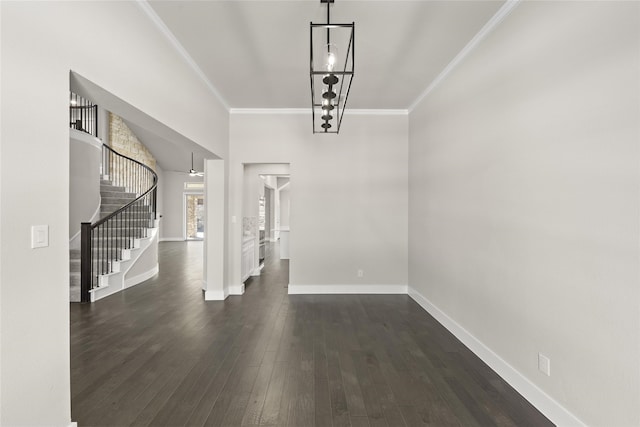 foyer entrance with crown molding and dark hardwood / wood-style floors