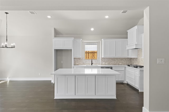 kitchen with a center island and white cabinets