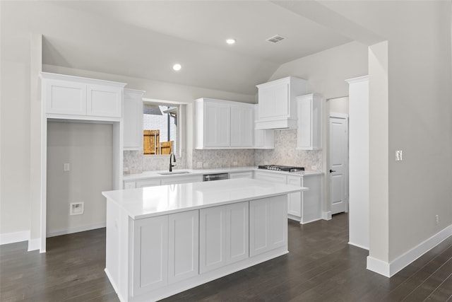 kitchen with white cabinetry, sink, dark hardwood / wood-style floors, and a kitchen island