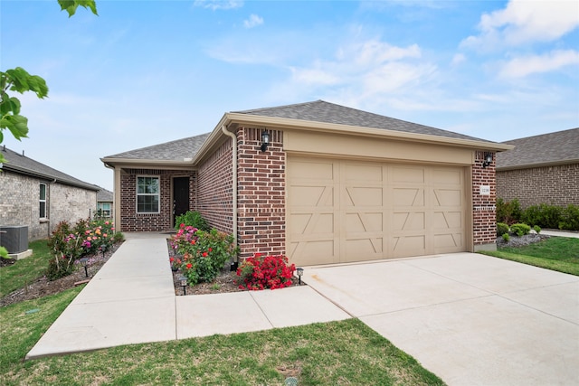 single story home with cooling unit and a garage