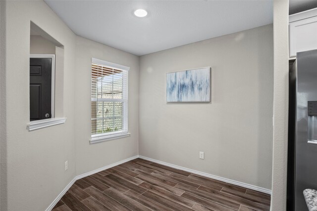 empty room with dark hardwood / wood-style floors