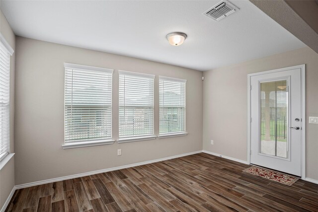 spare room featuring dark hardwood / wood-style floors