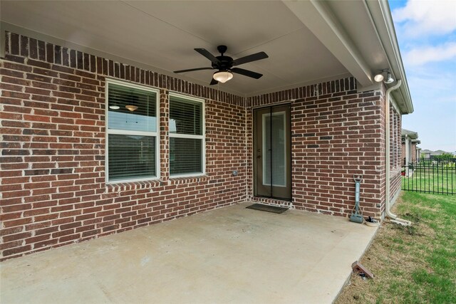 property entrance featuring ceiling fan and a patio area