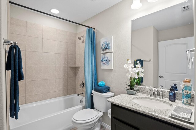 full bathroom with shower / bath combo, vanity, and toilet