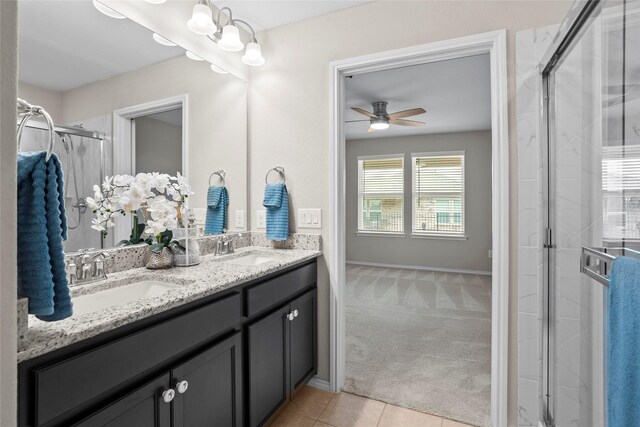 bathroom featuring walk in shower, vanity, ceiling fan, and tile patterned floors