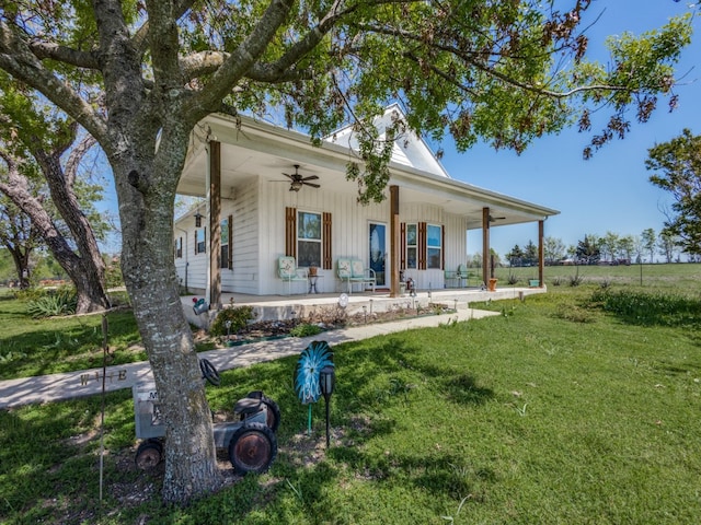 back of house with covered porch, a yard, and ceiling fan