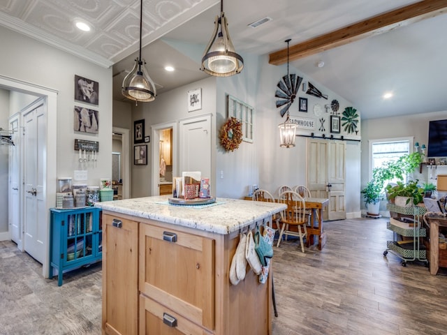 kitchen featuring light brown cabinets, light stone countertops, hanging light fixtures, vaulted ceiling with beams, and light wood-type flooring