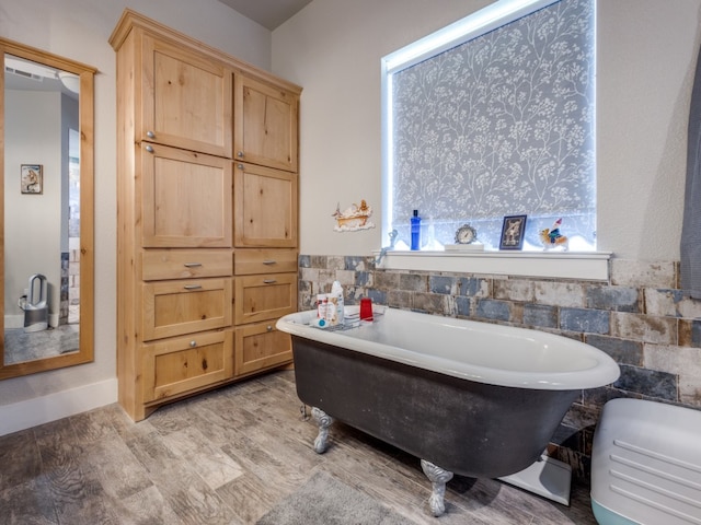 bathroom featuring wood-type flooring and a bathtub