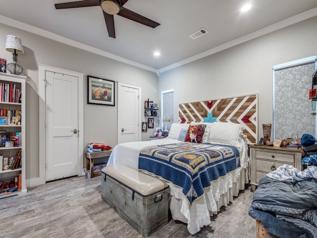 bedroom with ceiling fan, crown molding, and light wood-type flooring