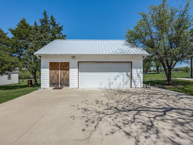 garage featuring a lawn