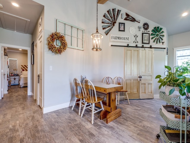 dining space with high vaulted ceiling and light hardwood / wood-style flooring